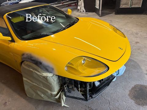 Yellow Ferrari 360 Spider in the shop with the front bumper cover removed, a front fender in primer and the wheel masked, during collision repair at Gold Coast Collision Center