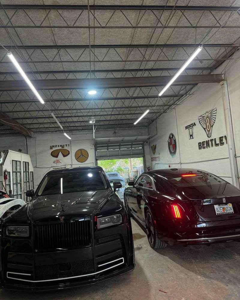 Rolls-Royce Cullinan and Spectre inside the Gold Coast Collision Center shop under LED lighting